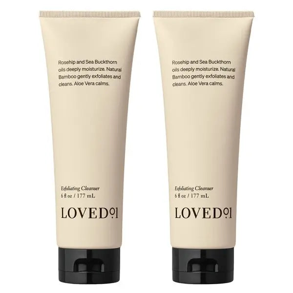 Two beige tubes of Loved 01 Deep Moisturizing Exfoliating Cleanser (6oz each), a 2-pack infused with nourishing Rosehip Oil and Sea Buckthorn Oil, both featuring black caps.
